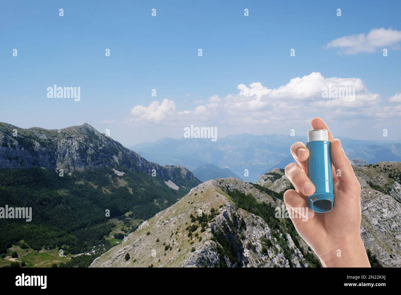 Man with asthma inhaler in mountains, closeup. Emergency first aid during outdoor recreation Stock Photo
