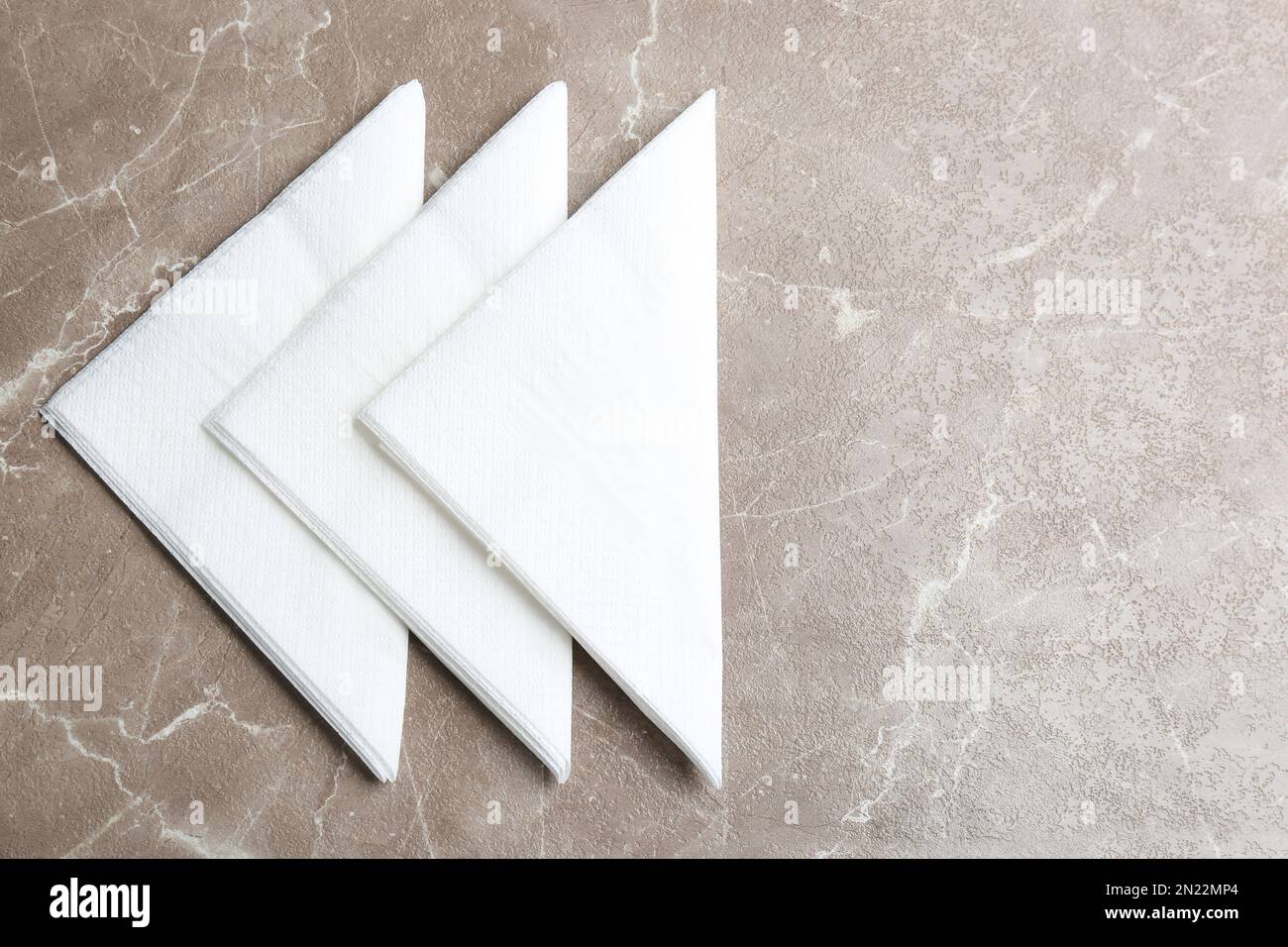 Clean napkins on marble table, flat lay. Space for text Stock Photo