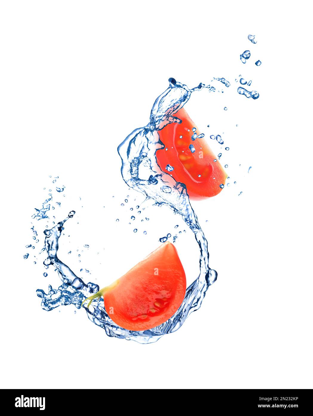 Fresh cut tomato with water splash on white background Stock Photo - Alamy