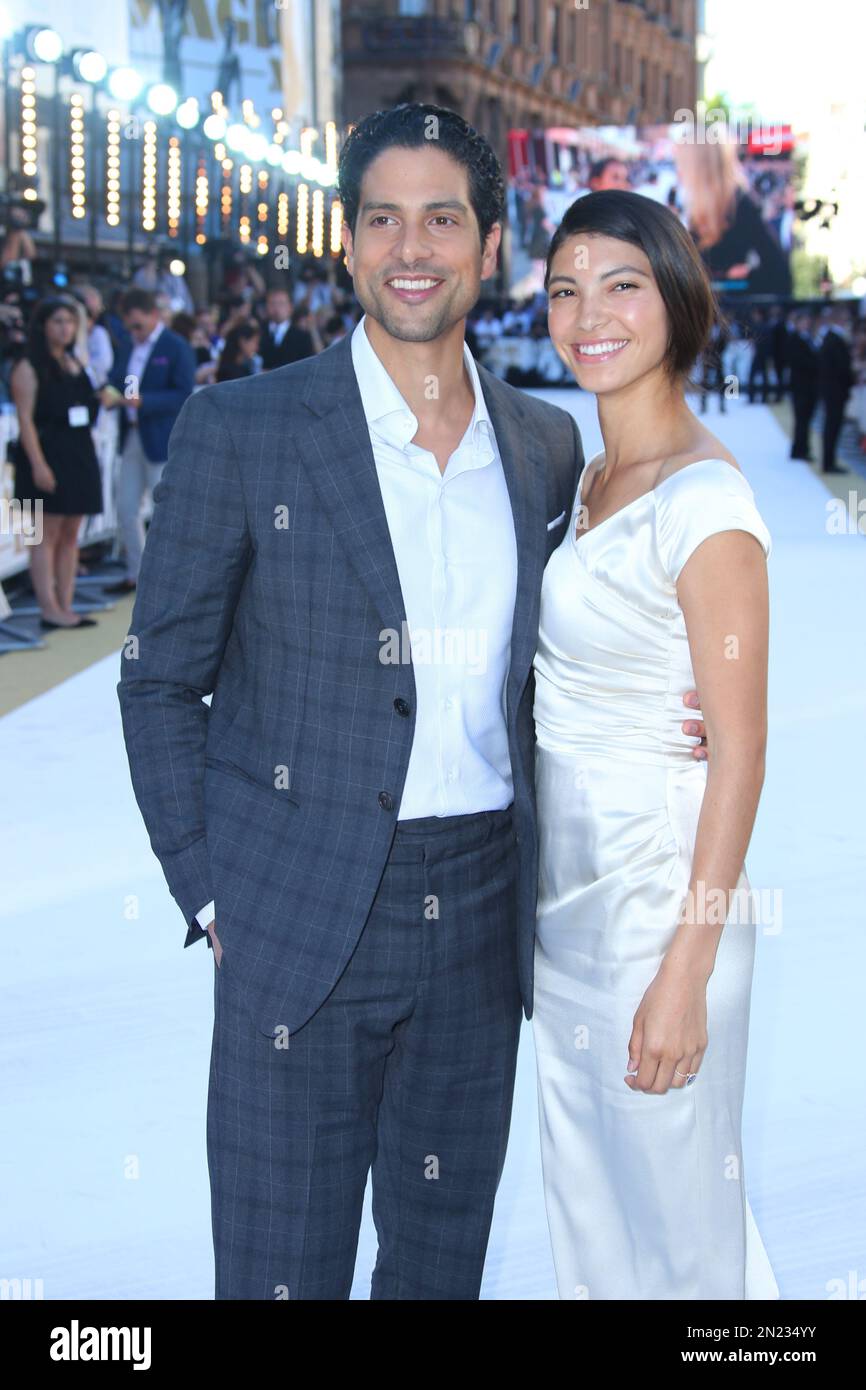Adam Rodriguez and Grace Gail pose for photographers upon arrival at