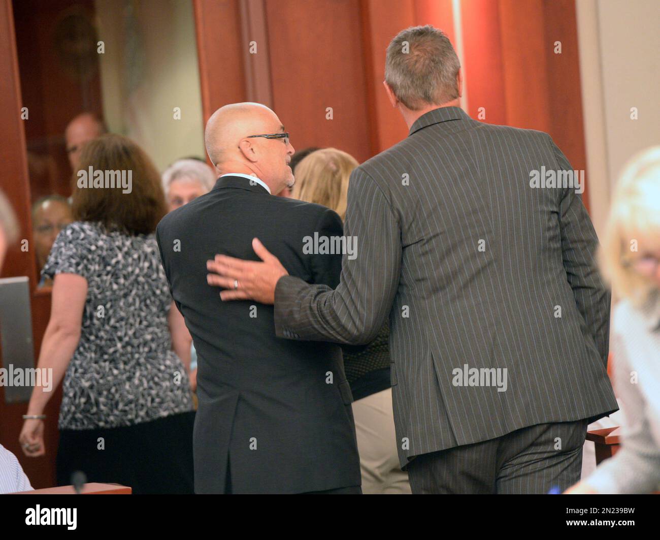 Former Utah Attorney General Mark Shurtleff pats his attorney, Richard ...