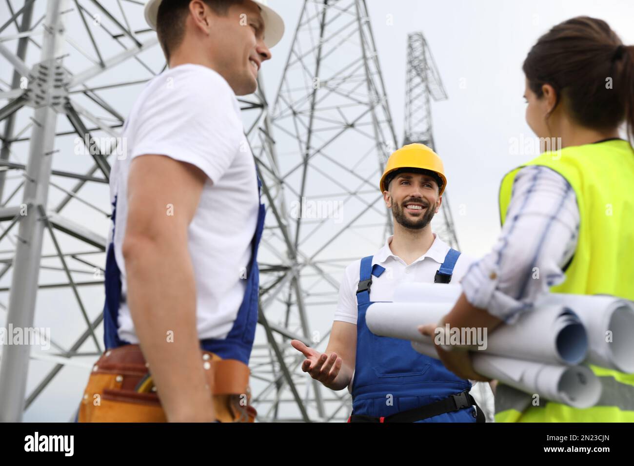 Professional engineers working on installation of electrical substation ...