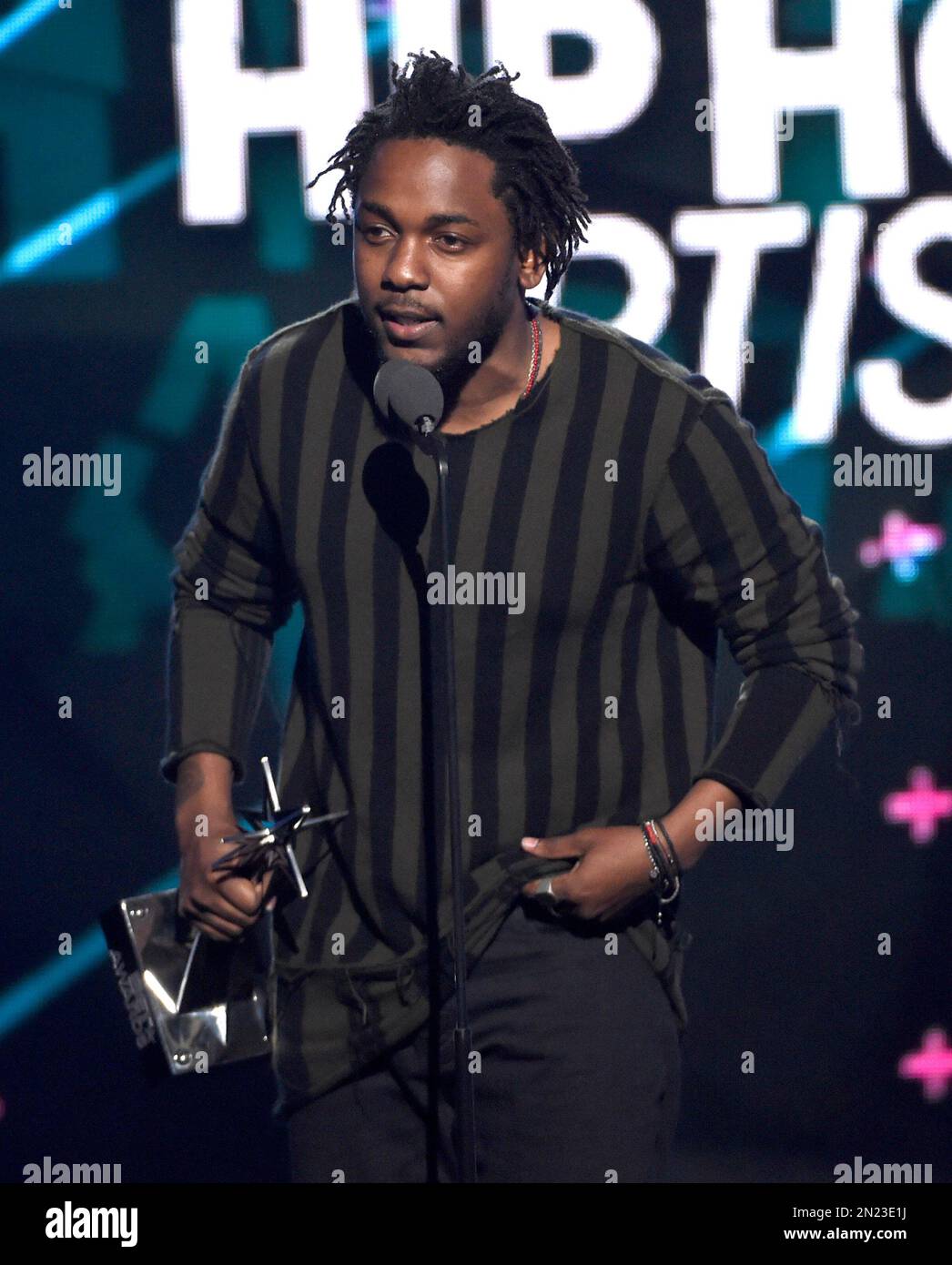 Kendrick Lamar accepts the award for best male hip hop artist at the
