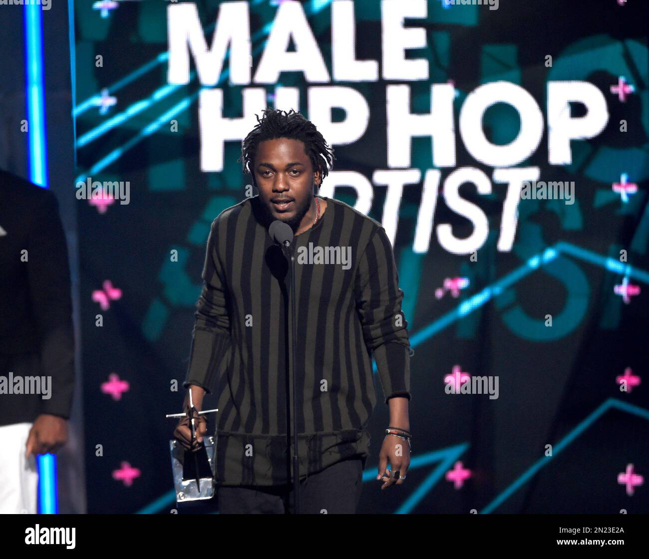 Kendrick Lamar accepts the award for best male hip hop artist at the