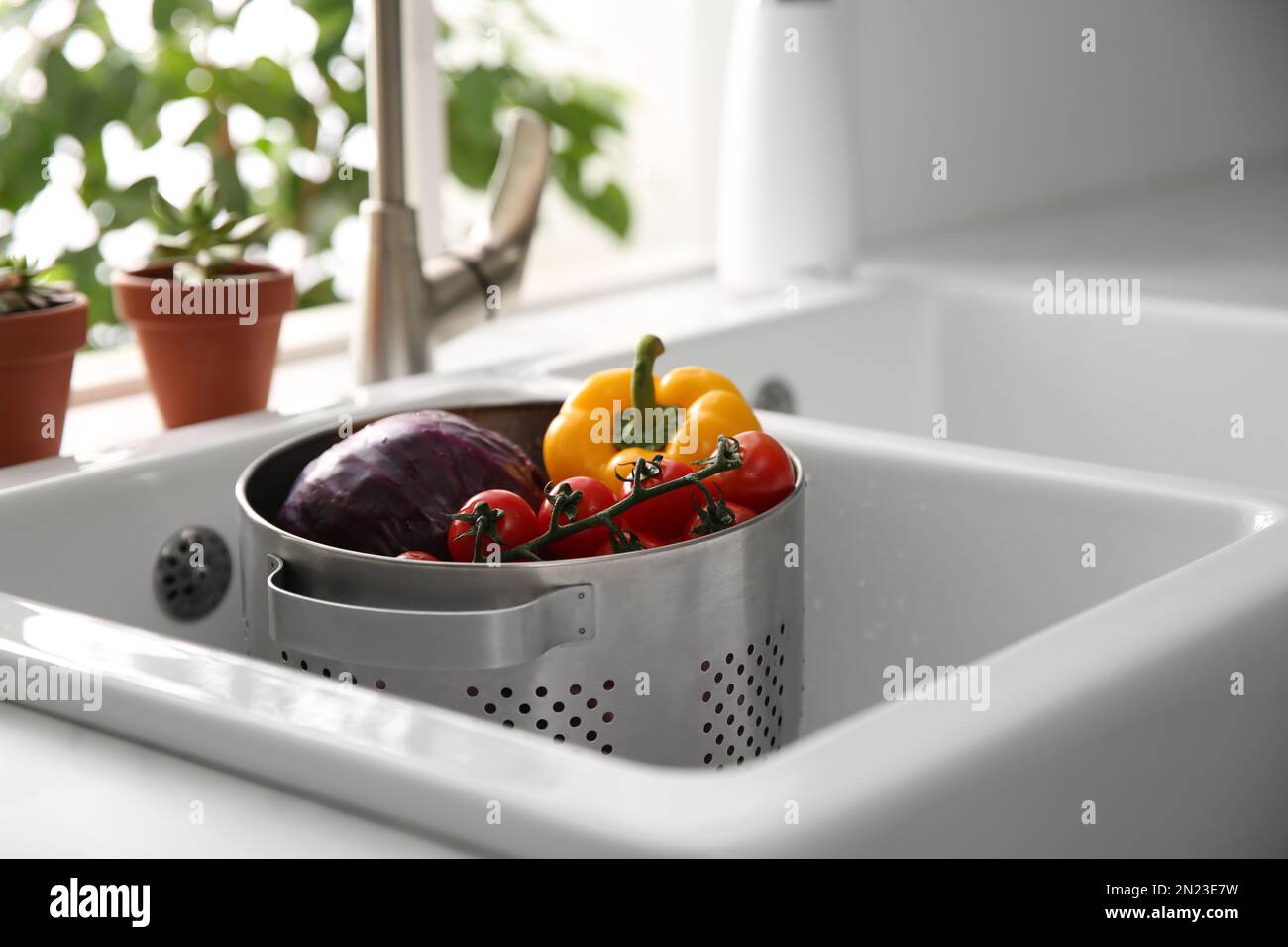 Colander pot with fresh vegetables in kitchen sink Stock Photo Alamy