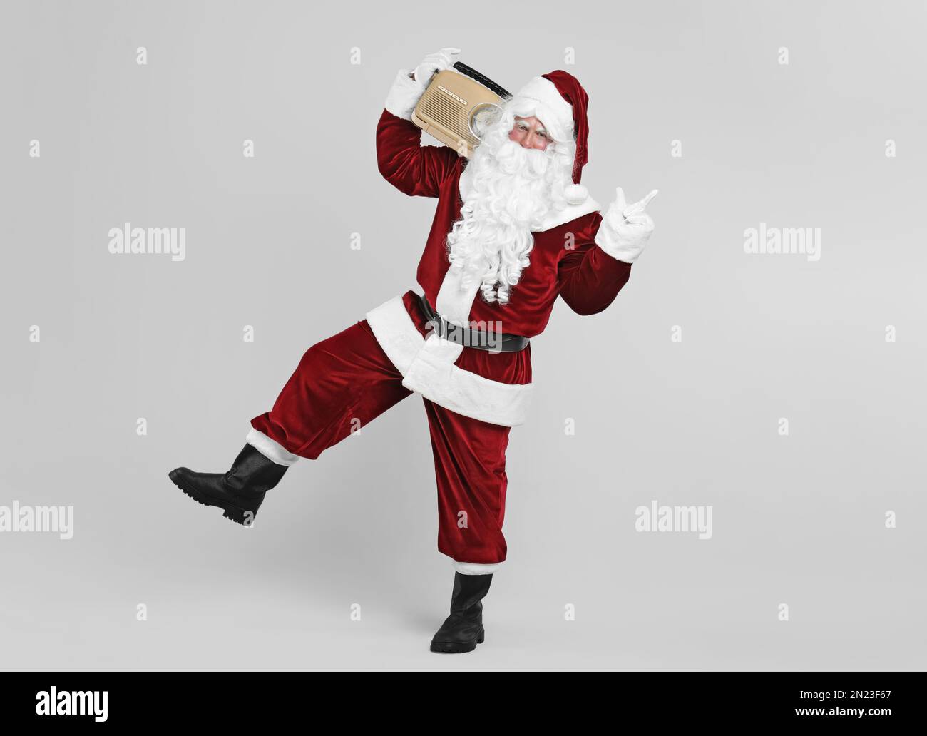 Santa Claus with vintage radio on light grey background. Christmas music  Stock Photo - Alamy