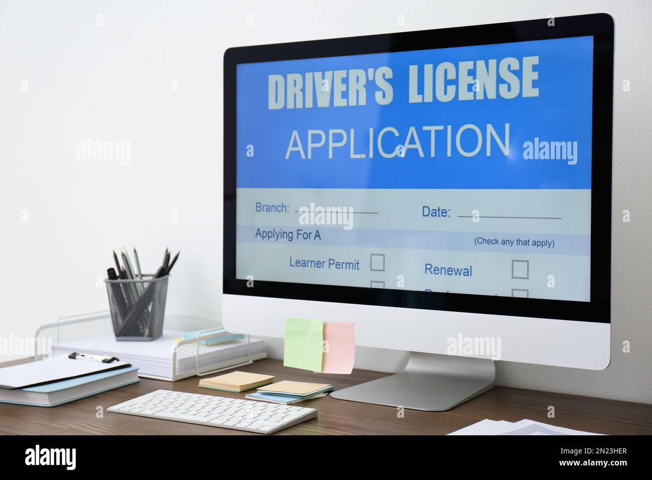 Computer with driver's license application form on table in office Stock Photo