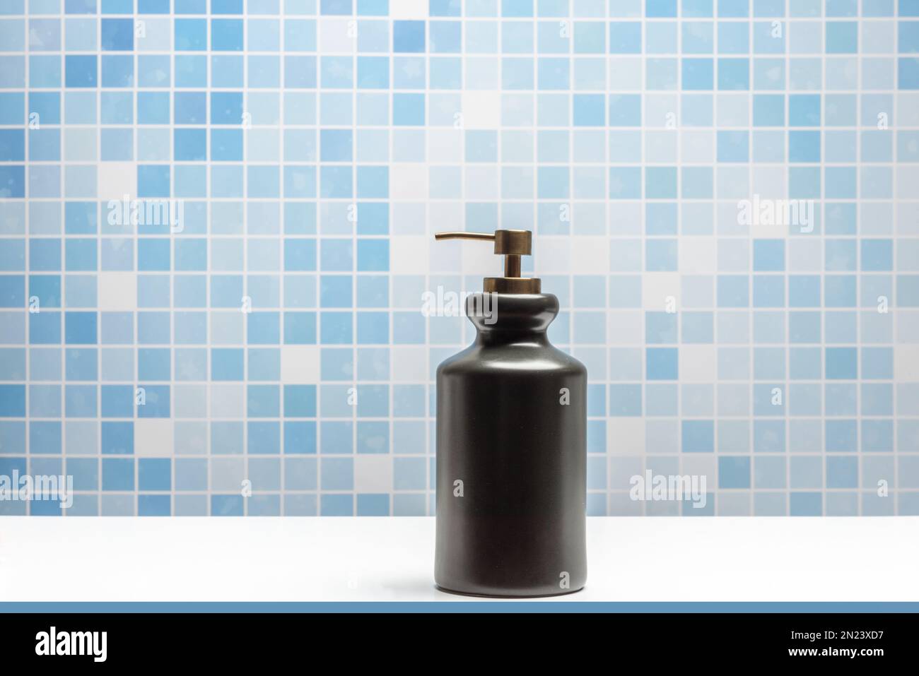 Black porcelain bowl with soap dispenser for hand washing in a blue