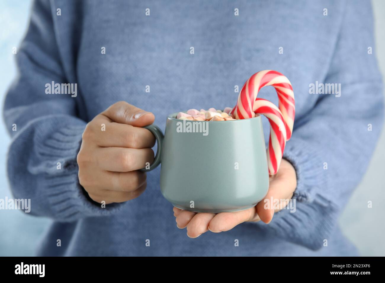 https://c8.alamy.com/comp/2N23XF6/woman-holding-cup-of-tasty-cocoa-with-marshmallows-and-christmas-candy-canes-closeup-2N23XF6.jpg