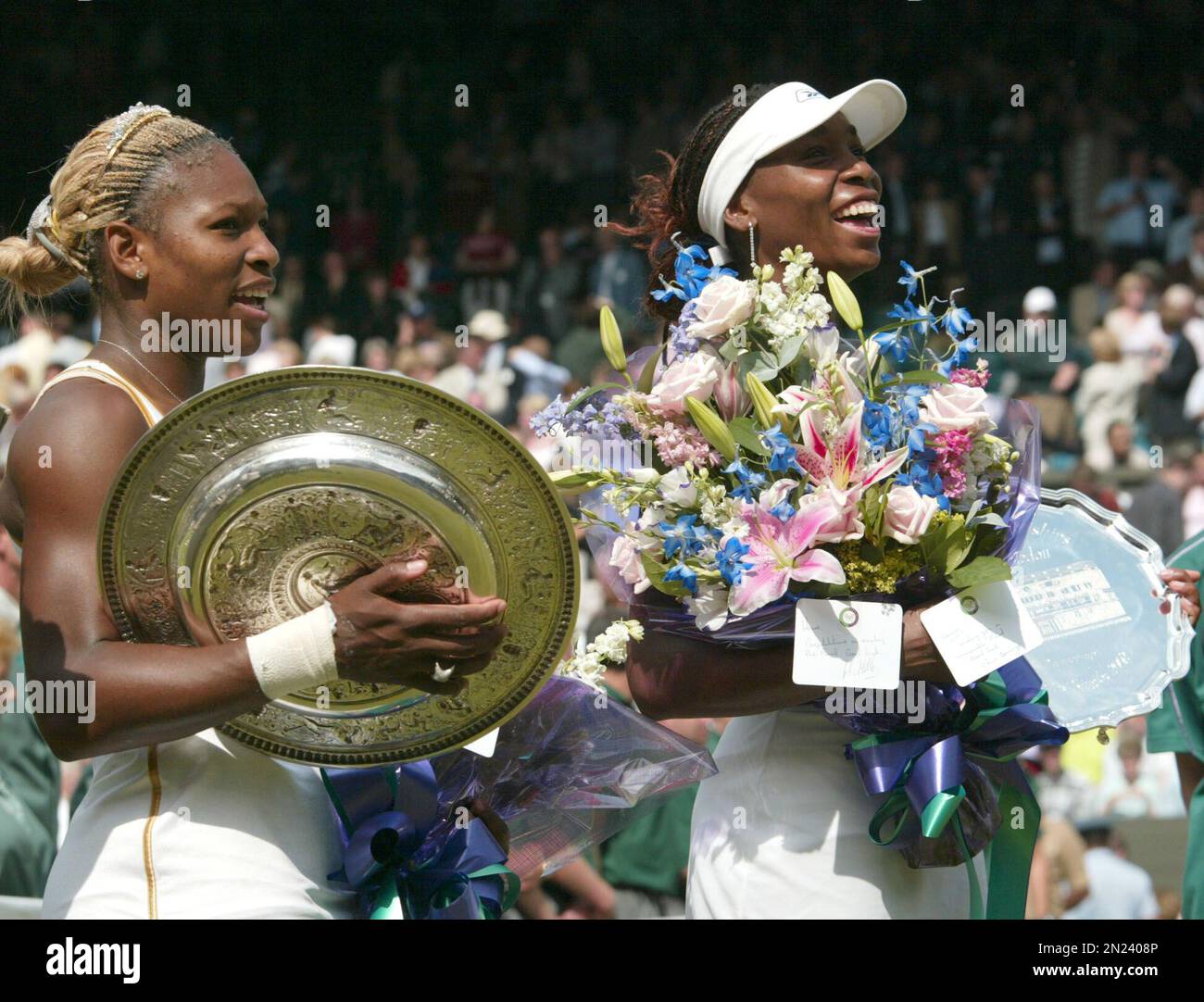 FILE In this July 6, 2002 file photo, Serena Williams, left, holds