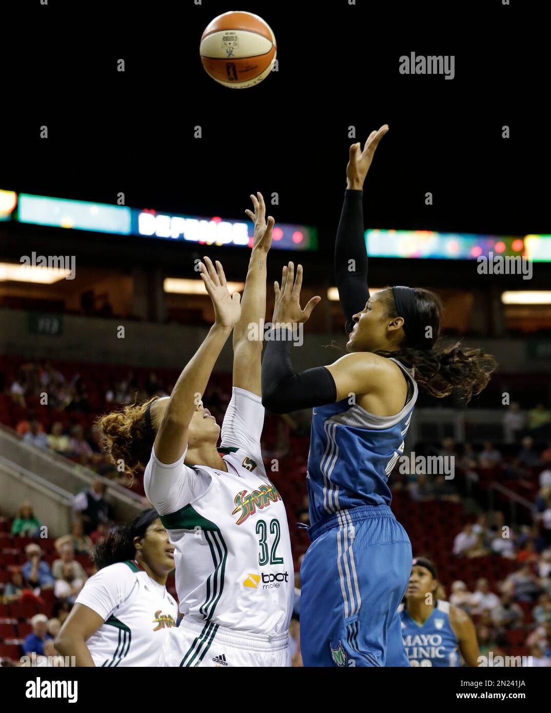 Minnesota Lynx's Maya Moore, right, shoots over Seattle Storm's Alysha ...