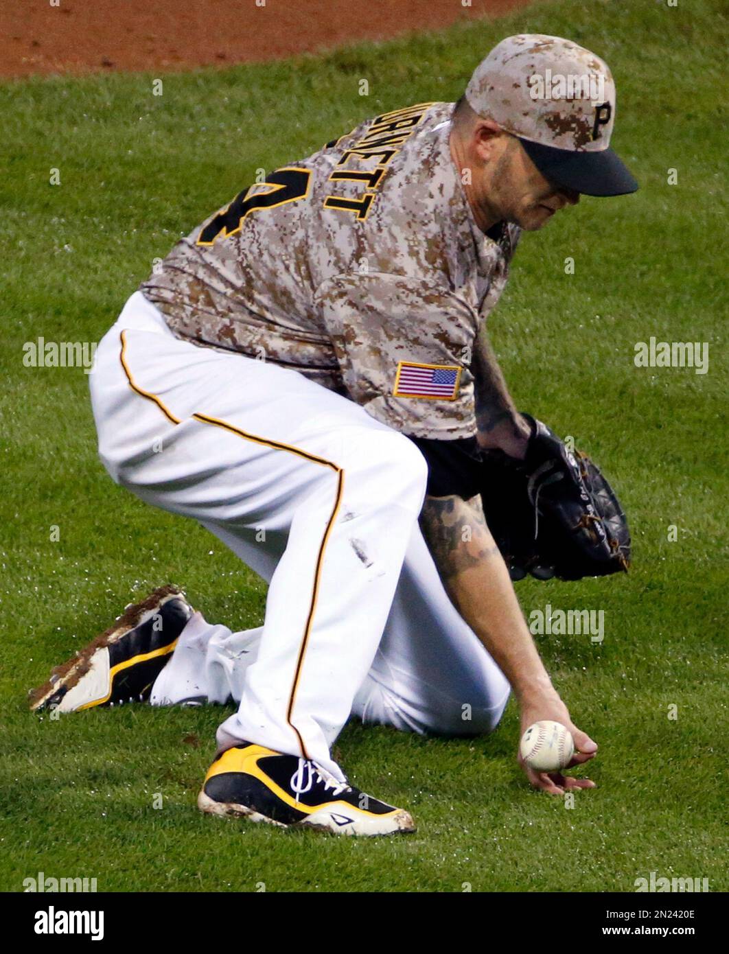 Pittsburgh Pirates starting pitcher A.J. (34) can't field a