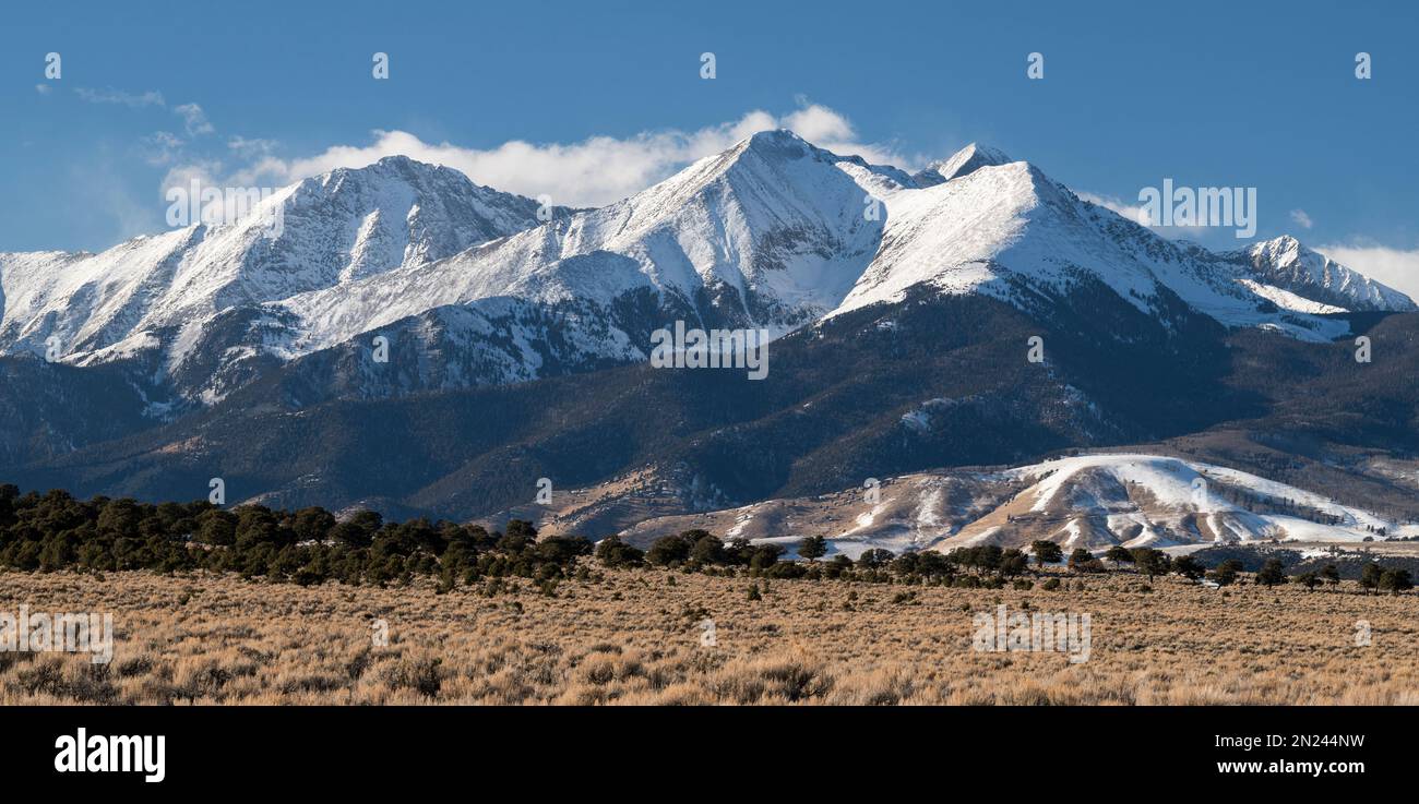 Several high mountain snow capped peaks including 4,372 Meter, Mount Blanca make up the dramatic Sierra Blanca Massif in southern Colorado. Stock Photo