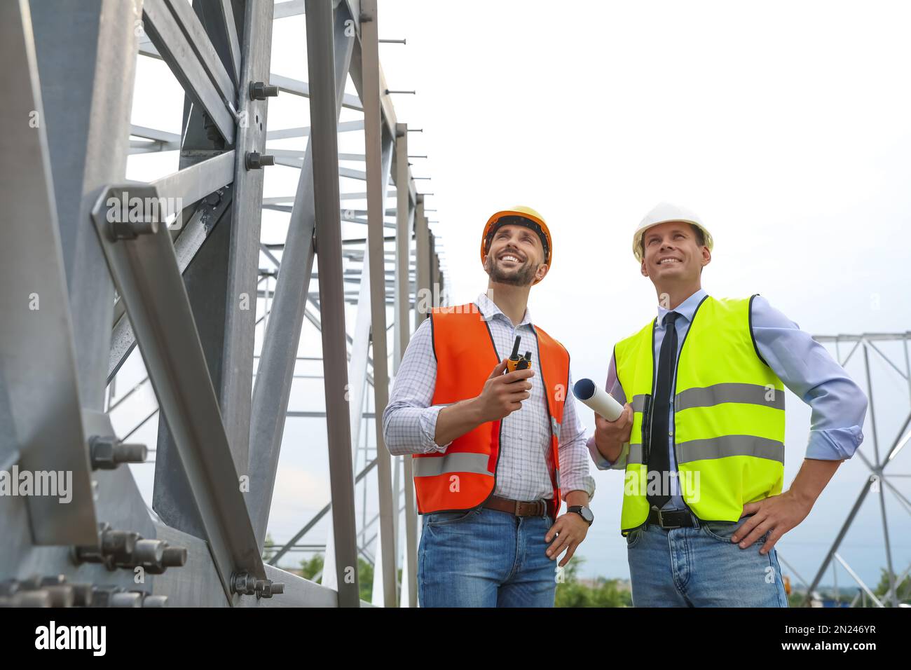 Professional engineers working on installation of electrical substation ...