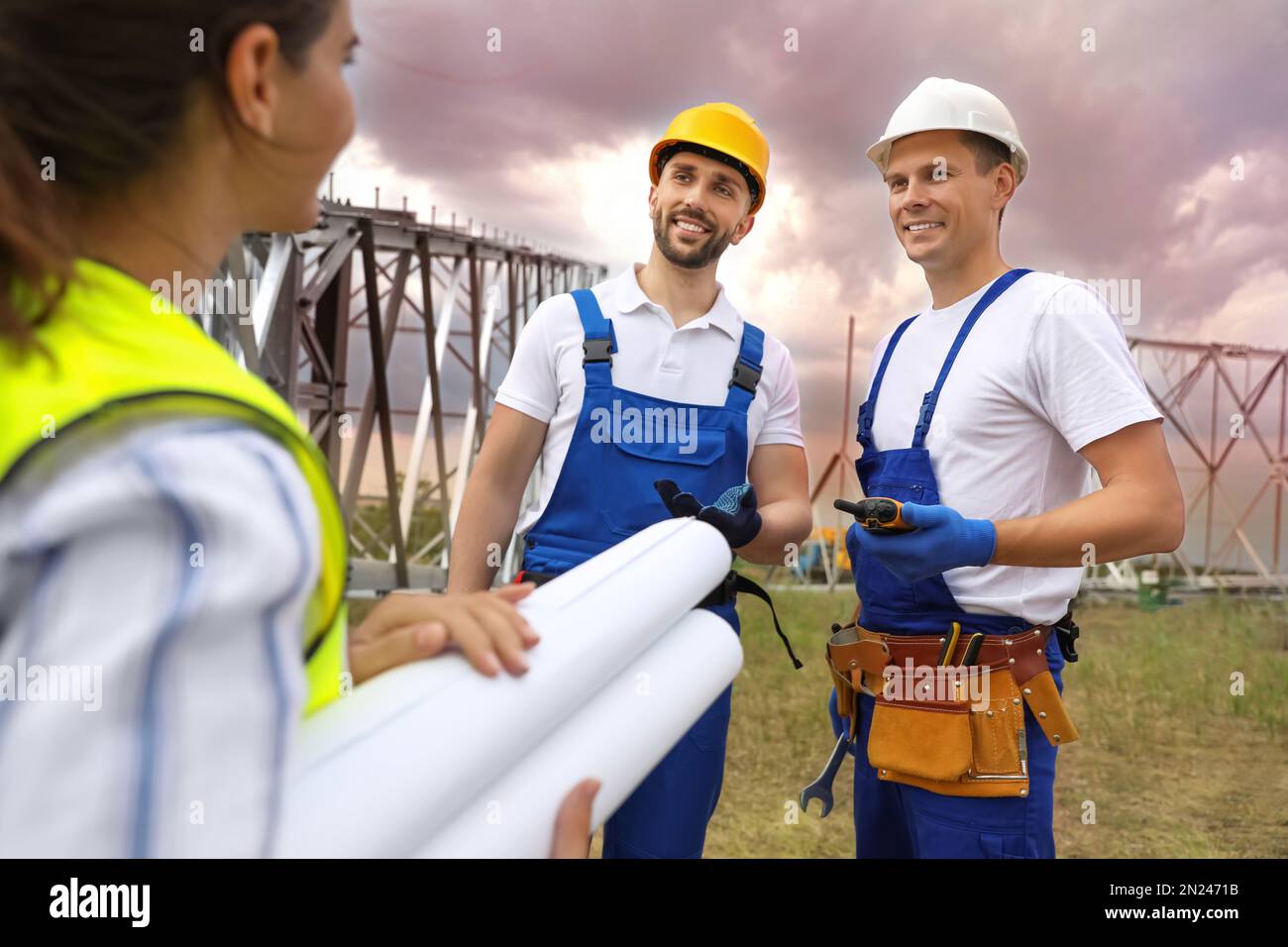 Professional engineers working on installation of electrical substation ...