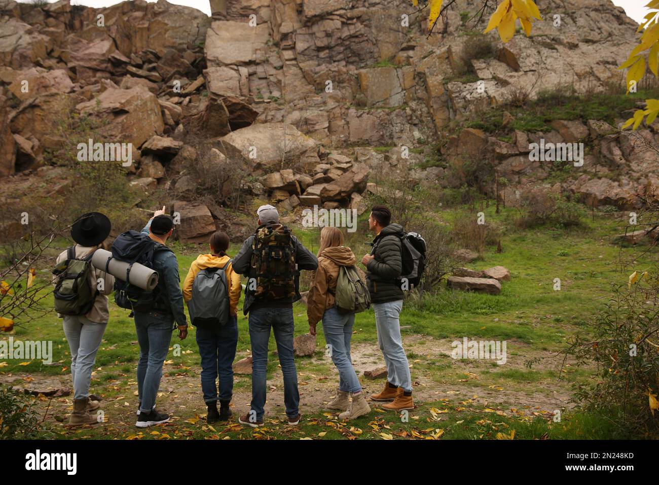 Group of hikers with backpacks in mountains, back view Stock Photo - Alamy
