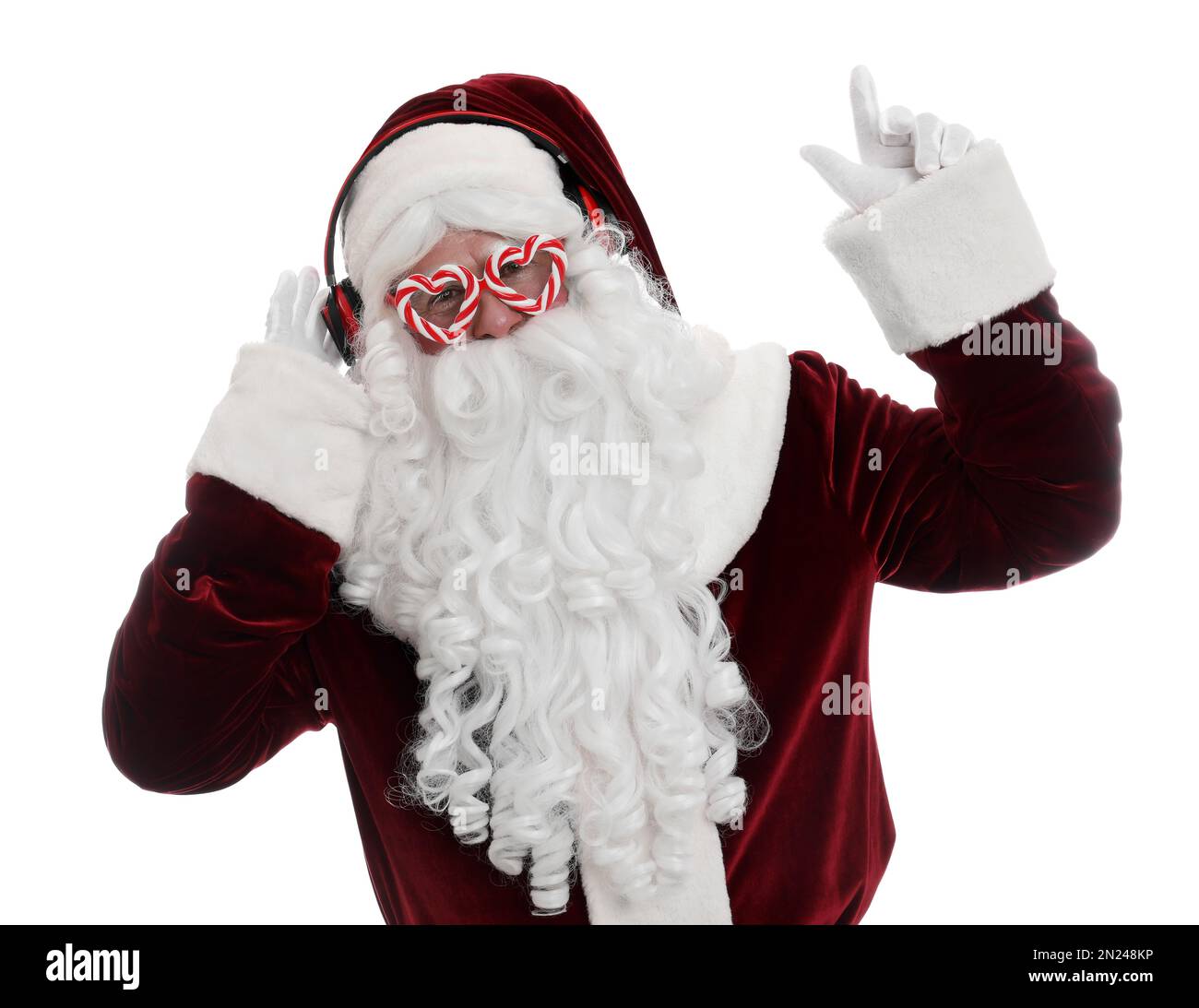 Santa Claus with headphones listening to Christmas music on white ...