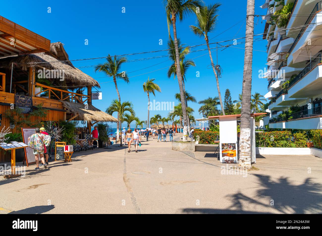 Shops, cafes, hotels and souvenir booths at the seaside promenade at Los Muertos Olas Altas beach in touristic Romantic Zone, Puerto Vallarta Mexico. Stock Photo
