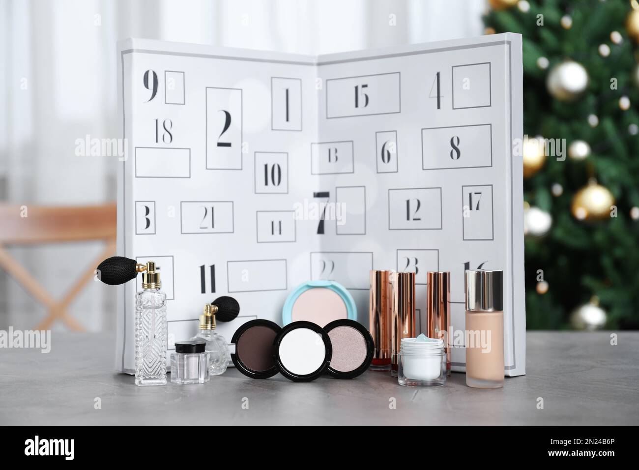 Christmas advent calendar with perfumes, skin care and decorative cosmetics  on table Stock Photo - Alamy