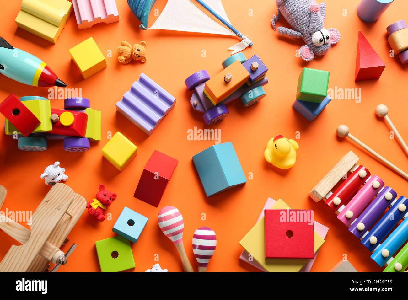 Flat lay composition with different toys on orange background Stock Photo
