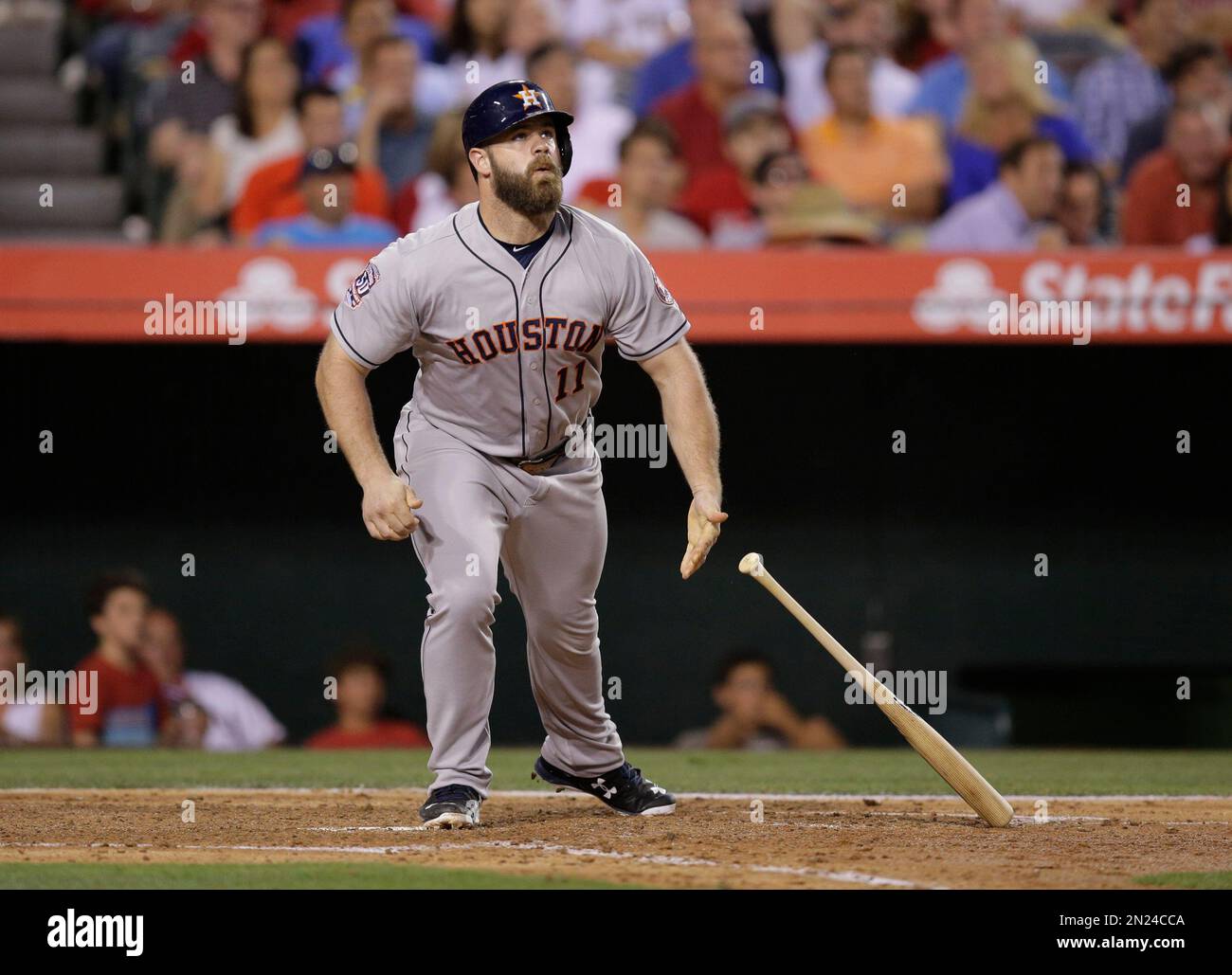 Houston Astros' Evan Gattis watches his sacrifice fly ball during the  fourth inning of a baseball game against the Los Angeles Angels, Tuesday,  June 23, 2015, in Anaheim, Calif. (AP Photo/Jae C.