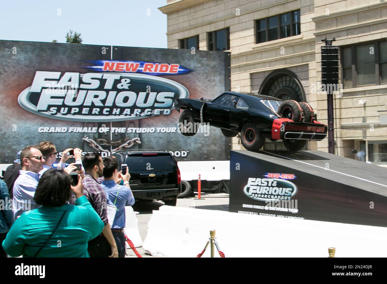 A stunt car flies through the air at the World Premiere of "Fast