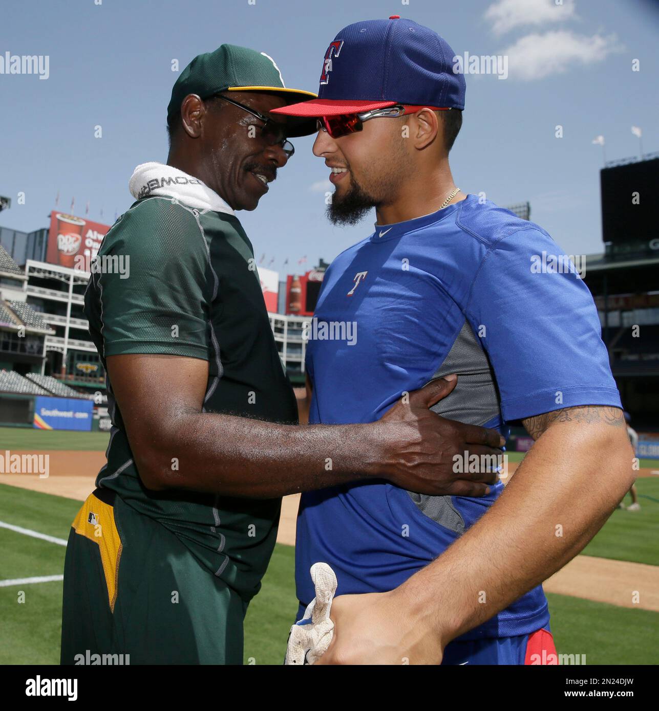 Oakland Athletics fielding coach Ron Washington, left, visits with