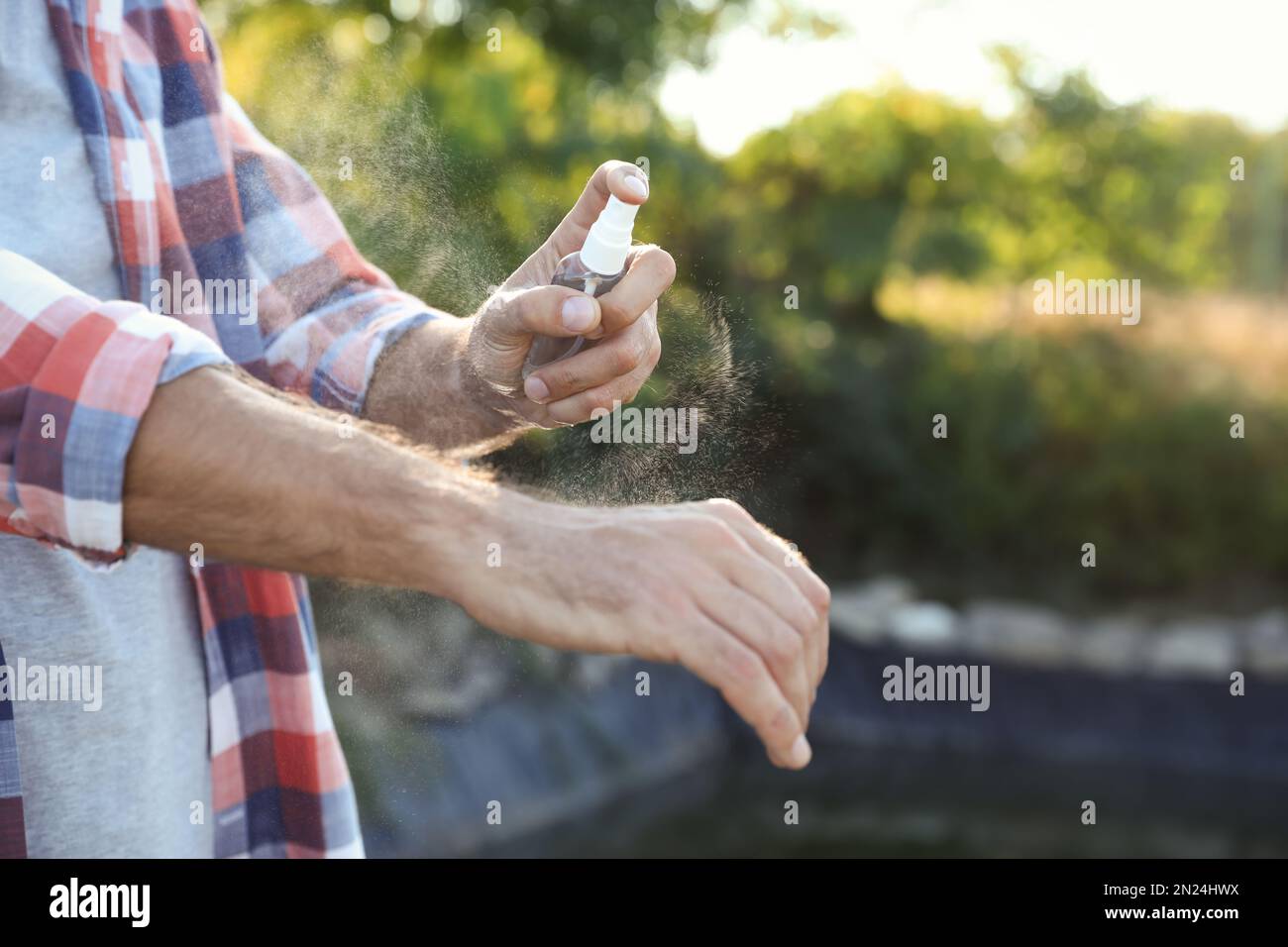 Man using mosquito repellent spray hi-res stock photography and images ...