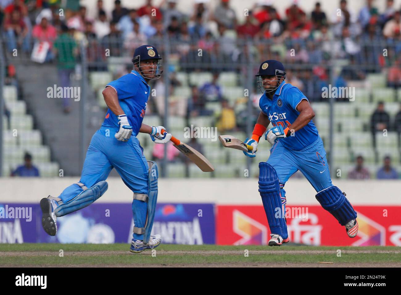 India’s captain Mahendra Singh Dhoni and his teammate Suresh Raina run ...