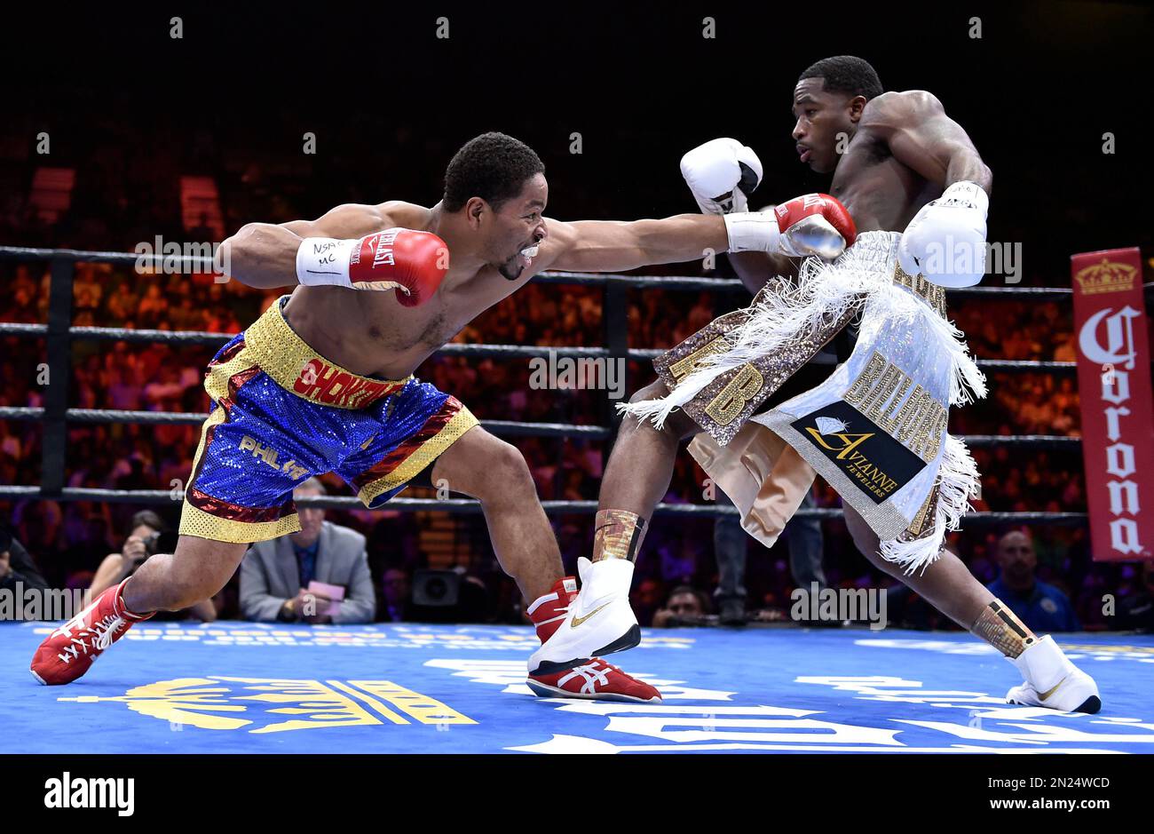 Shawn Porter, left, throws a punch at Adrien Broner during their