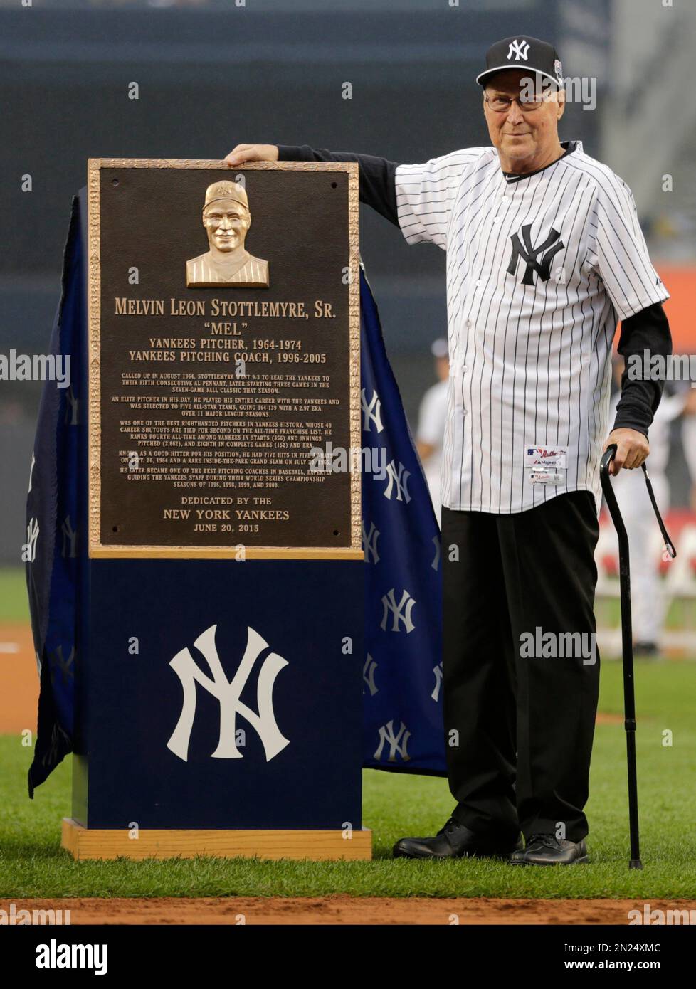 Mel Stottlemyre poses for photographs with a plaque he was awarded