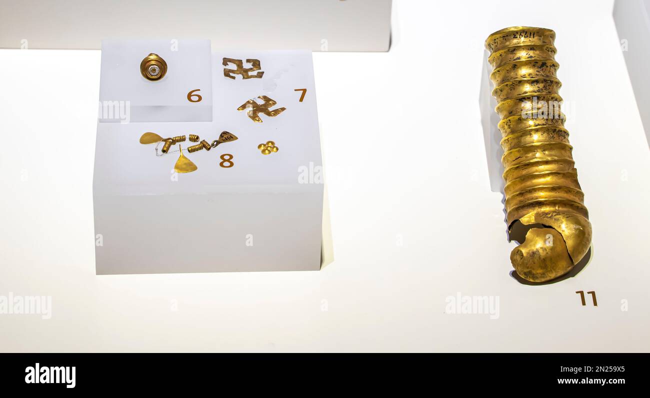 Gold Button,gold swastika shaped ornament fragment, gold necklace and necklace beads, gold handle. Alacahöyük. 2500-2250 B.C. Stock Photo