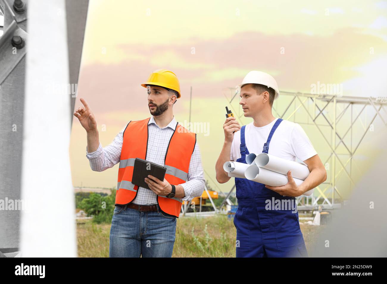 Professional engineers working on installation of electrical substation ...