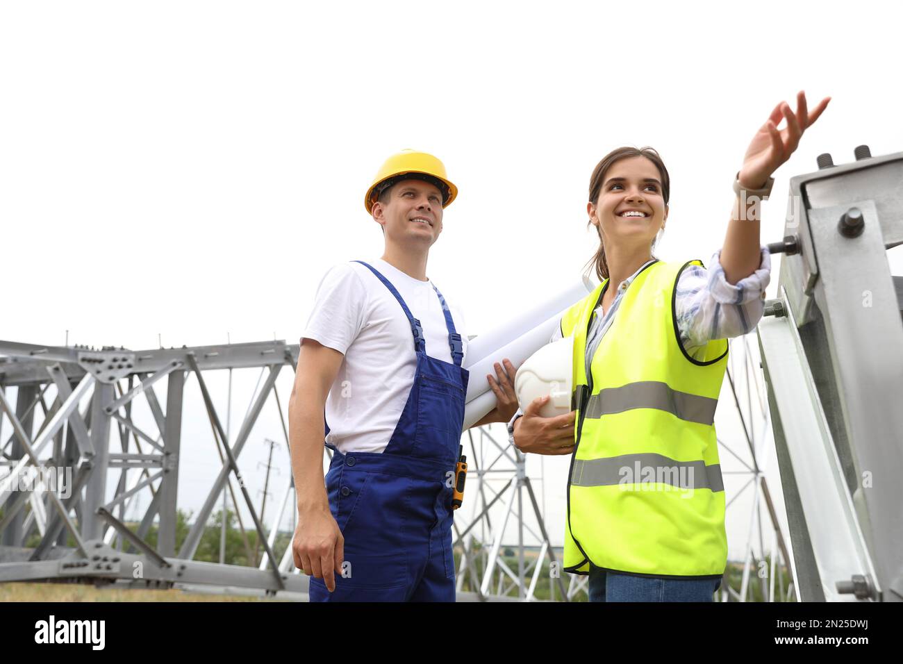 Professional engineers working on installation of electrical substation ...