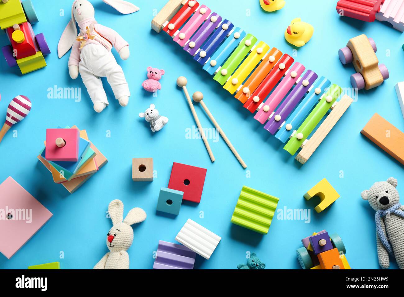 Flat lay composition with different toys on light blue background Stock Photo