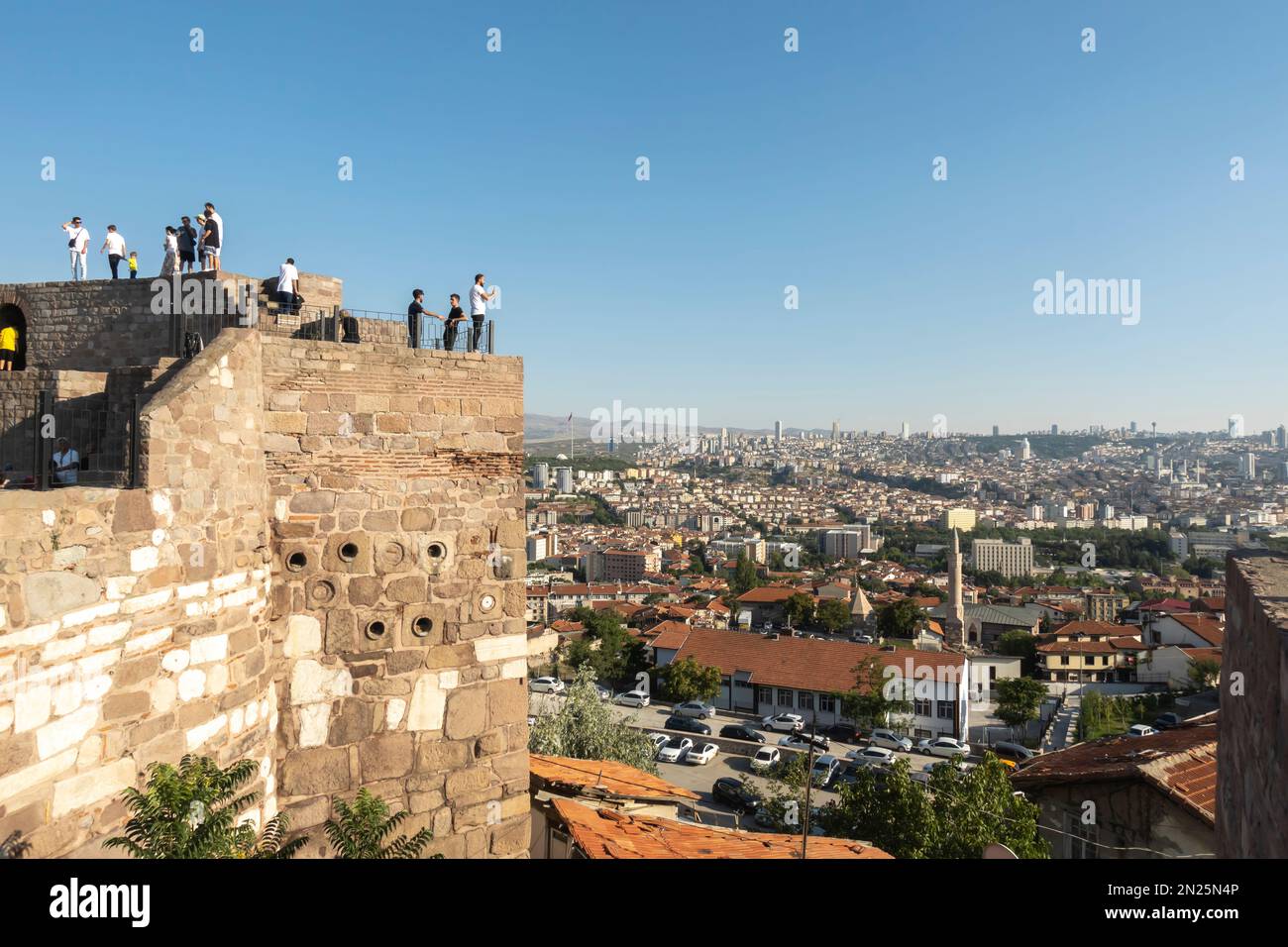 Ankara travel. Tourists on the Ankara Castle with a scenic view of the capital of Turkey. Fortification was constructed in 7th century Stock Photo