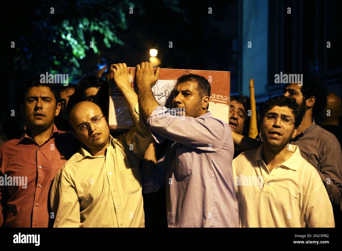 Iranian Mourners Carry A Flag-draped Coffin Of A Soldier Killed During ...