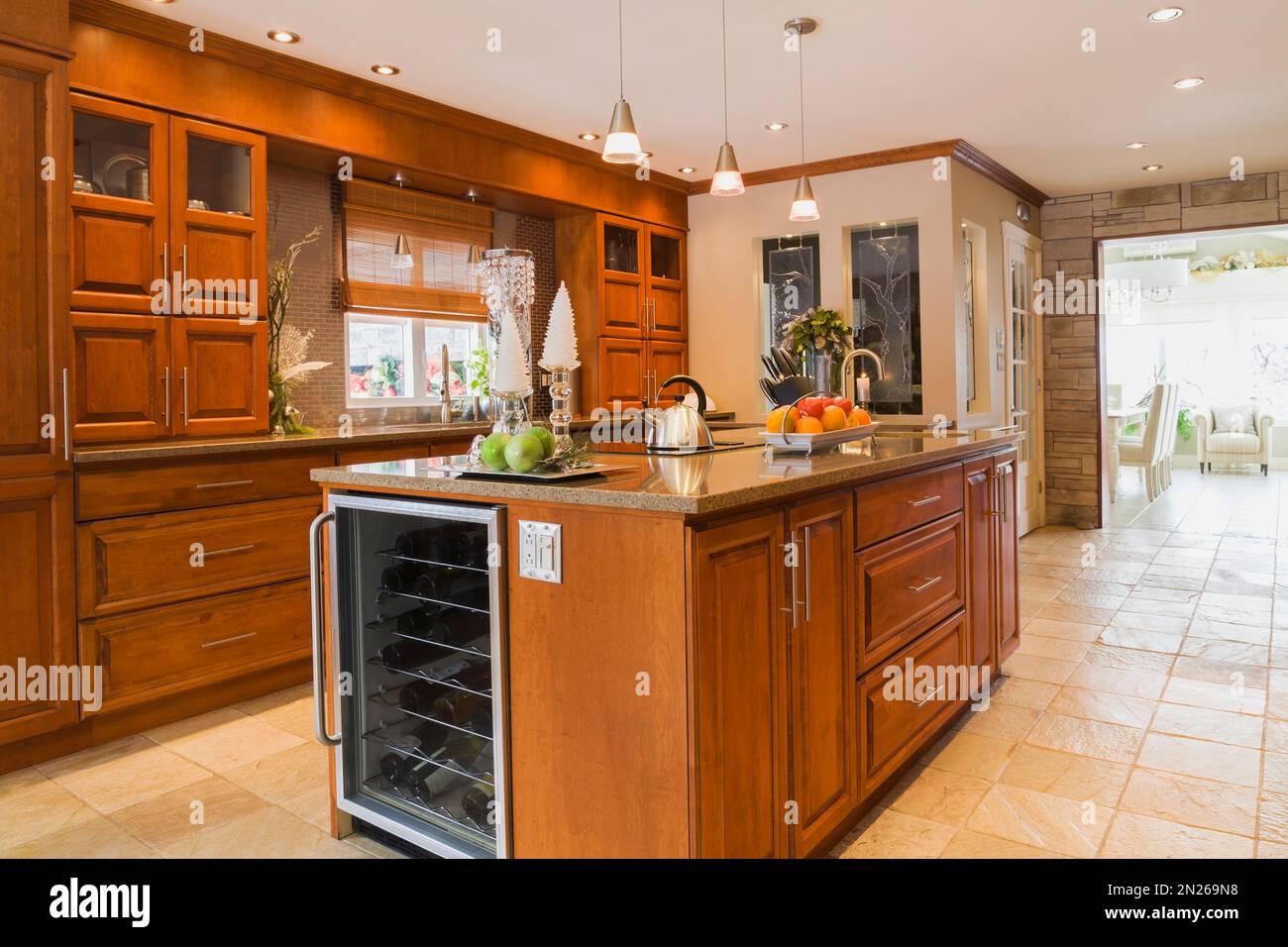 Cherry wood and island with quartz countertops in kitchen inside old renovated circa