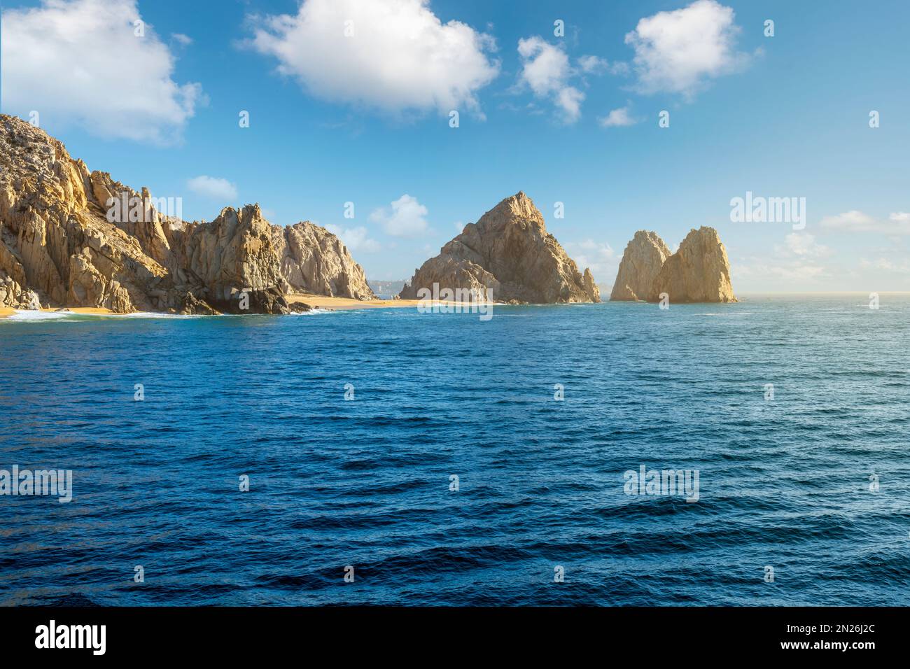 Sea view as sunlight hits the sandy Playa de Los Amantas, known as Lover's Beach at the Land's End Los Arcos rock formation at Cabo San Lucas, Mexico Stock Photo