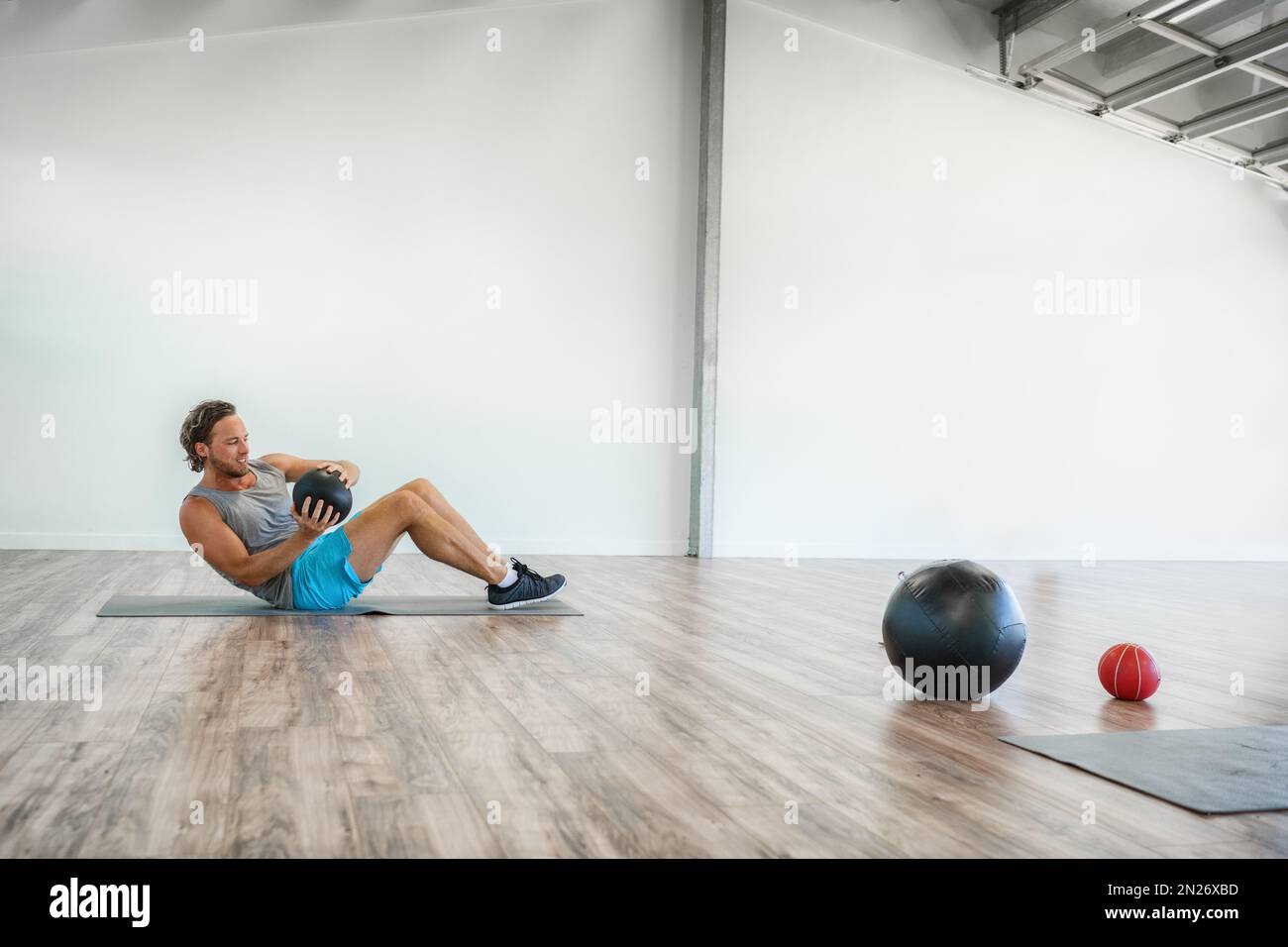 Gym medicine ball workout abs exercise at home. Man working out core