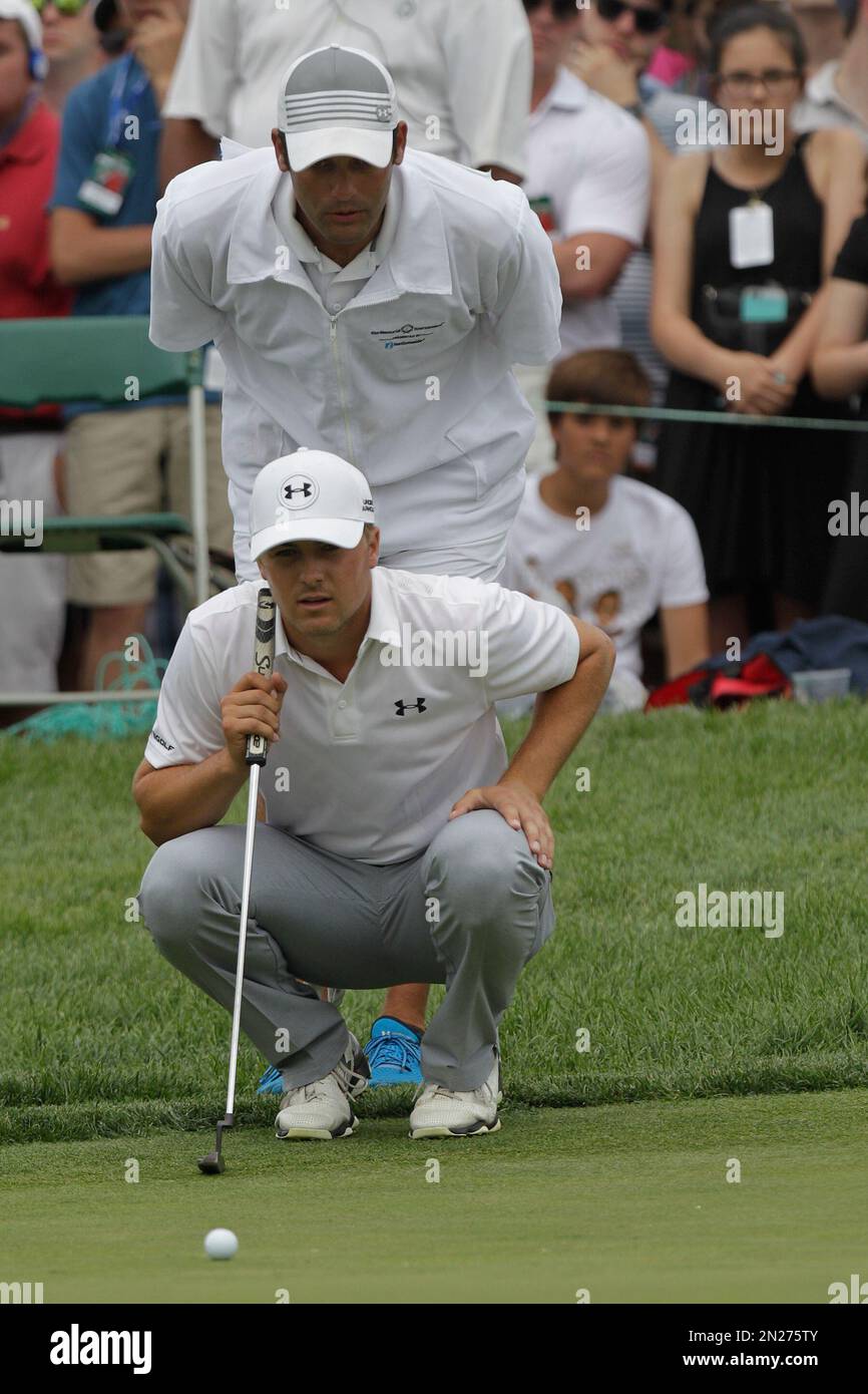 Jordan Spieth, front, and his caddie Michael Greller line up a putt during the Memorial golf