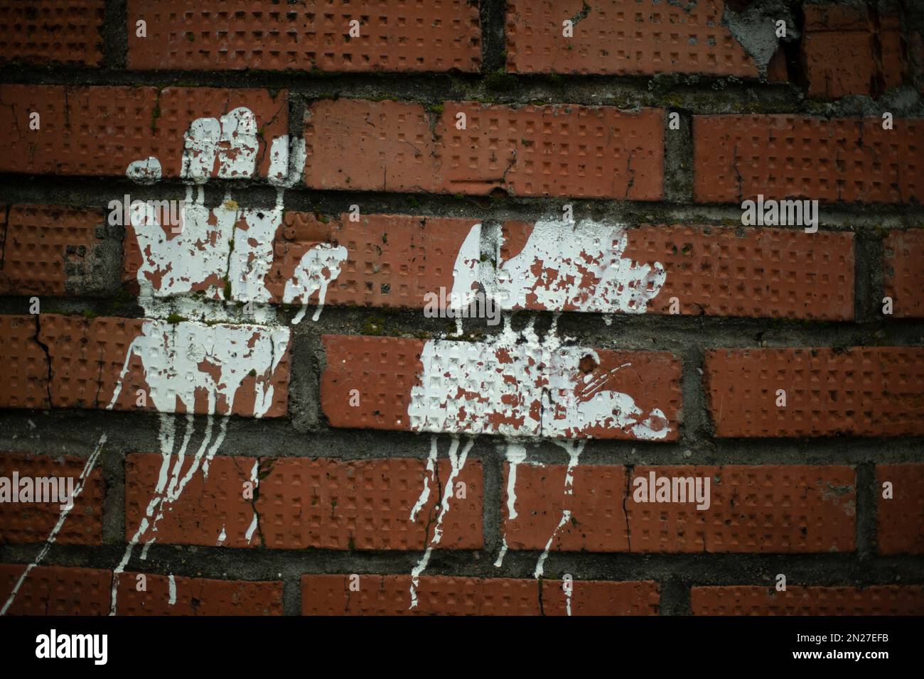 Handprint paint. Imprint on brick wall. White paint silhouette of palm