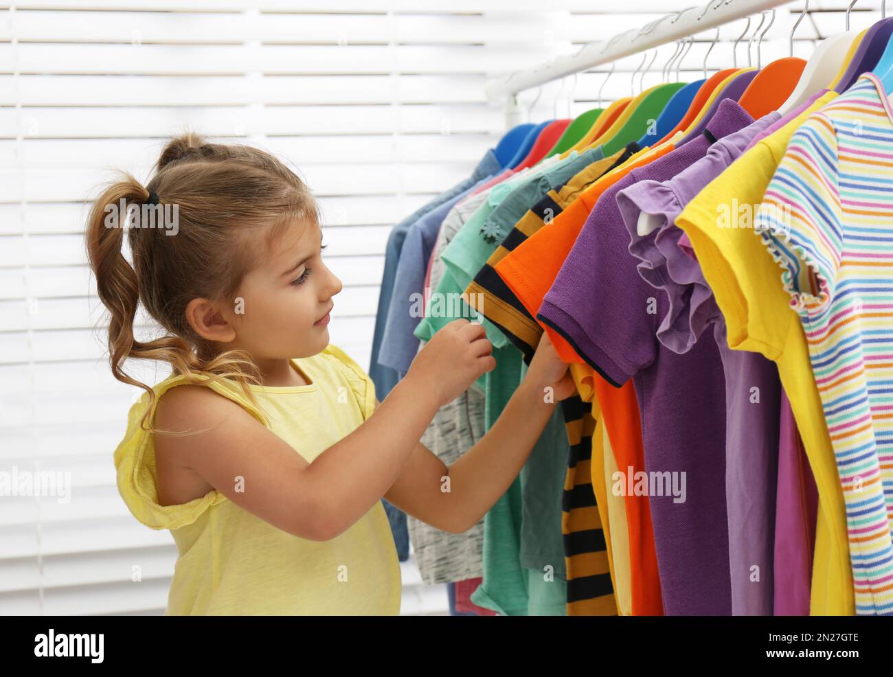 Little girl clothes choosing hires stock photography and images Alamy