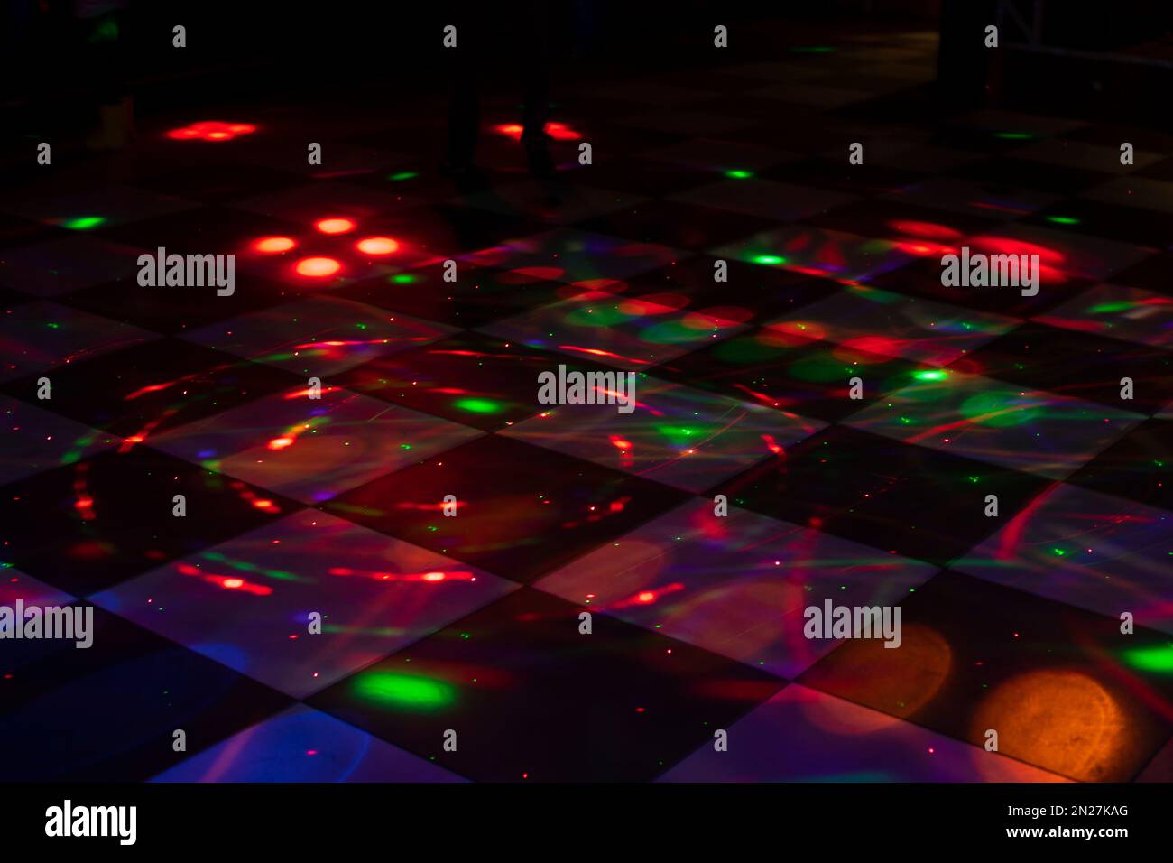 Disco dance floor. Light on dance floor. Colored spots on floor. Lights
