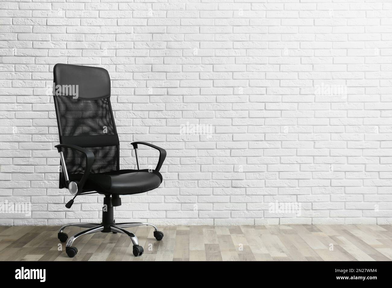 Comfortable office chair near white brick wall indoors. Space for text Stock Photo Alamy