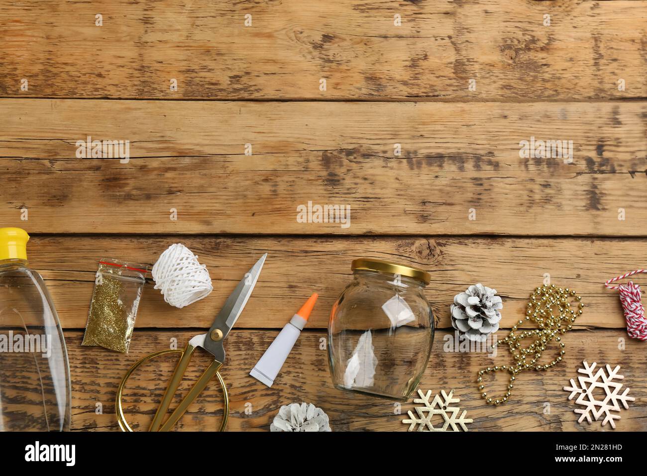 Instruments and materials for snow globe on wooden table, flat lay ...