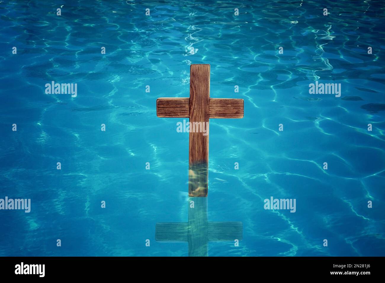 Wooden cross in water for religious ritual known as baptism Stock Photo ...