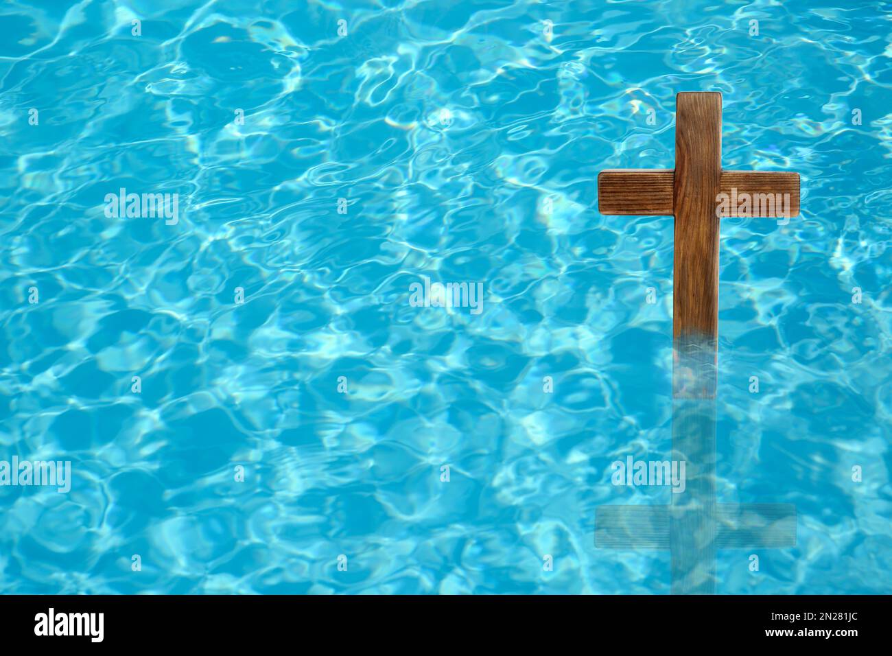 Wooden cross in water for religious ritual known as baptism Stock Photo ...