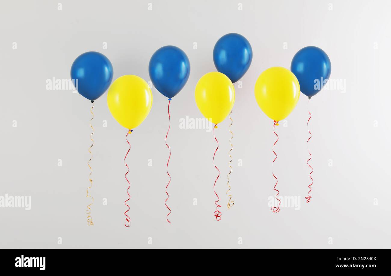 Many balloons in colors of Ukrainian flag on light background Stock Photo