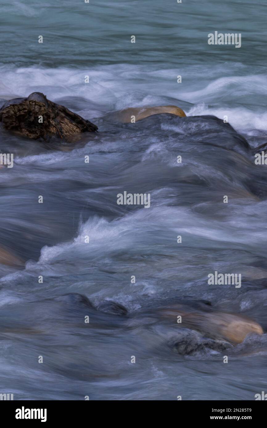 Natural background of silky textures of river currents over dark river ...